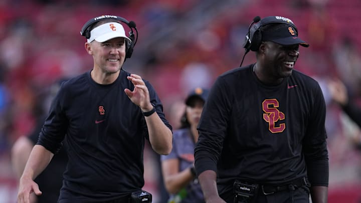 Sep 2, 2023; Los Angeles, California, USA; Southern California Trojans head coach Lincoln Riley (leff) and wide receivers coach Dennis Simmons react against the Nevada Wolf Pack in the second half at United Airlines Field at Los Angeles Memorial Coliseum. Sep 2, 2023; Los Angeles, California, USA; Southern California Trojans head coach Lincoln Riley (leff) and wide receivers coach Dennis Simmons react against the Nevada Wolf Pack in the second half at United Airlines Field at Los Angeles Memorial Coliseum.