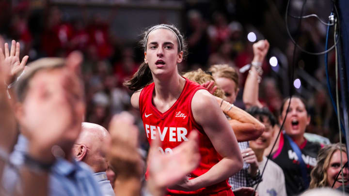 Indiana Fever guard Caitlin Clark (22) celebrates with fans behind the basket Friday, Aug. 16, 2024, during the game at Gainbridge Fieldhouse in Indianapolis.