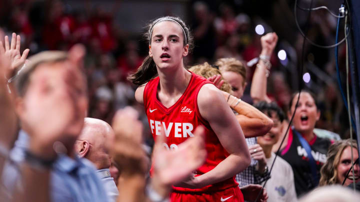 Indiana Fever guard Caitlin Clark (22) celebrates with fans behind the basket Friday, Aug. 16, 2024, during the game at Gainbridge Fieldhouse in Indianapolis.