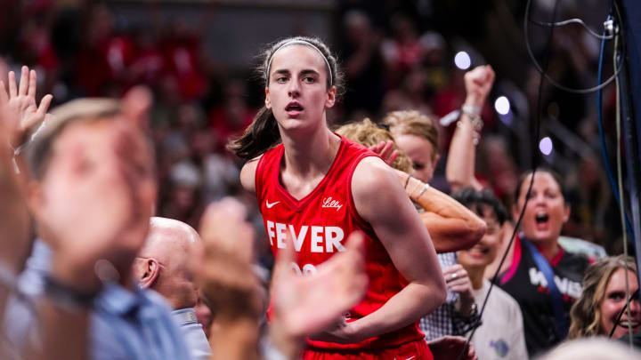 Indiana Fever guard Caitlin Clark (22) celebrates with fans behind the basket Friday, Aug. 16, 2024, during the game at Gainbridge Fieldhouse in Indianapolis.