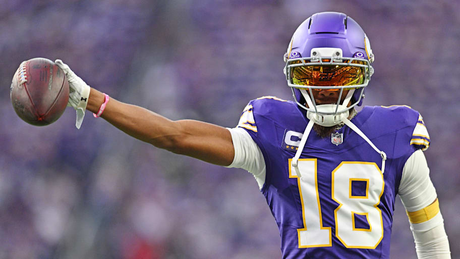 Justin Jefferson holds out a football during a Minnesota Vikings–Atlanta Falcons game.