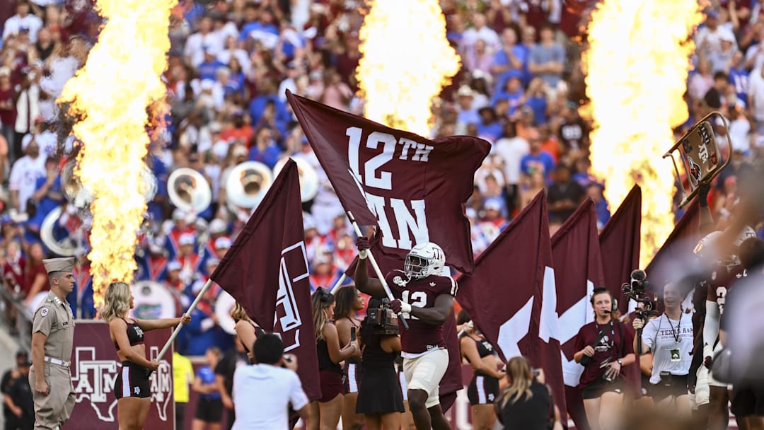 Texas A&M Aggies defensive end Nana Boadi-Owusu (12) runs out with the 12th Man flag prior to the game against the Florida Gators at Kyle Field. Texas A&M Aggies defensive end Nana Boadi-Owusu (12) runs out with the 12th Man flag prior to the game against the Florida Gators at Kyle Field.