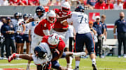 Sep 6, 2025; Raleigh, North Carolina, USA; North Carolina State Wolfpack defensive end Sabastian Harsh (54) tackles Virginia Cavaliers running back J'Mari Taylor (3) during the first half of the game at Carter-Finley Stadium. Mandatory Credit: Jaylynn Nash-Imagn Images