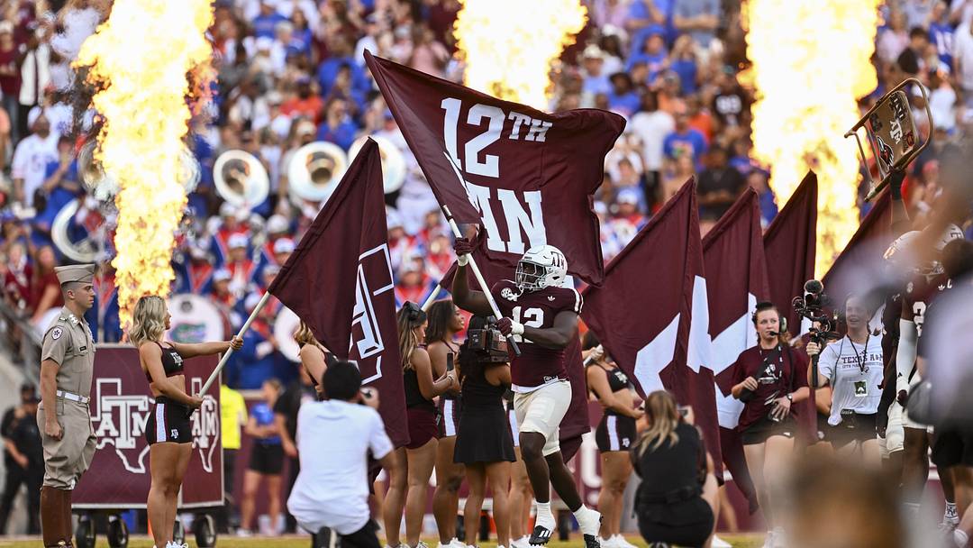 Texas A&M Aggies defensive end Nana Boadi-Owusu runs out with the 12th Man flag before the game against the Florida Gators at Kyle Field. 