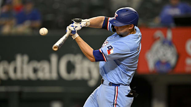 Texas Rangers shortstop Corey Seager hits a single, wearing a light blue jersey and a blue batting helmet.  Texas Rangers shortstop Corey Seager hits a single, wearing a light blue jersey and a blue batting helmet.