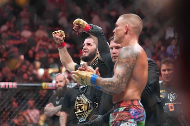 Islam Makhachev (red gloves) celebrates defeating Dustin Poirier (blue gloves) during UFC 302 at Prudential Center. 