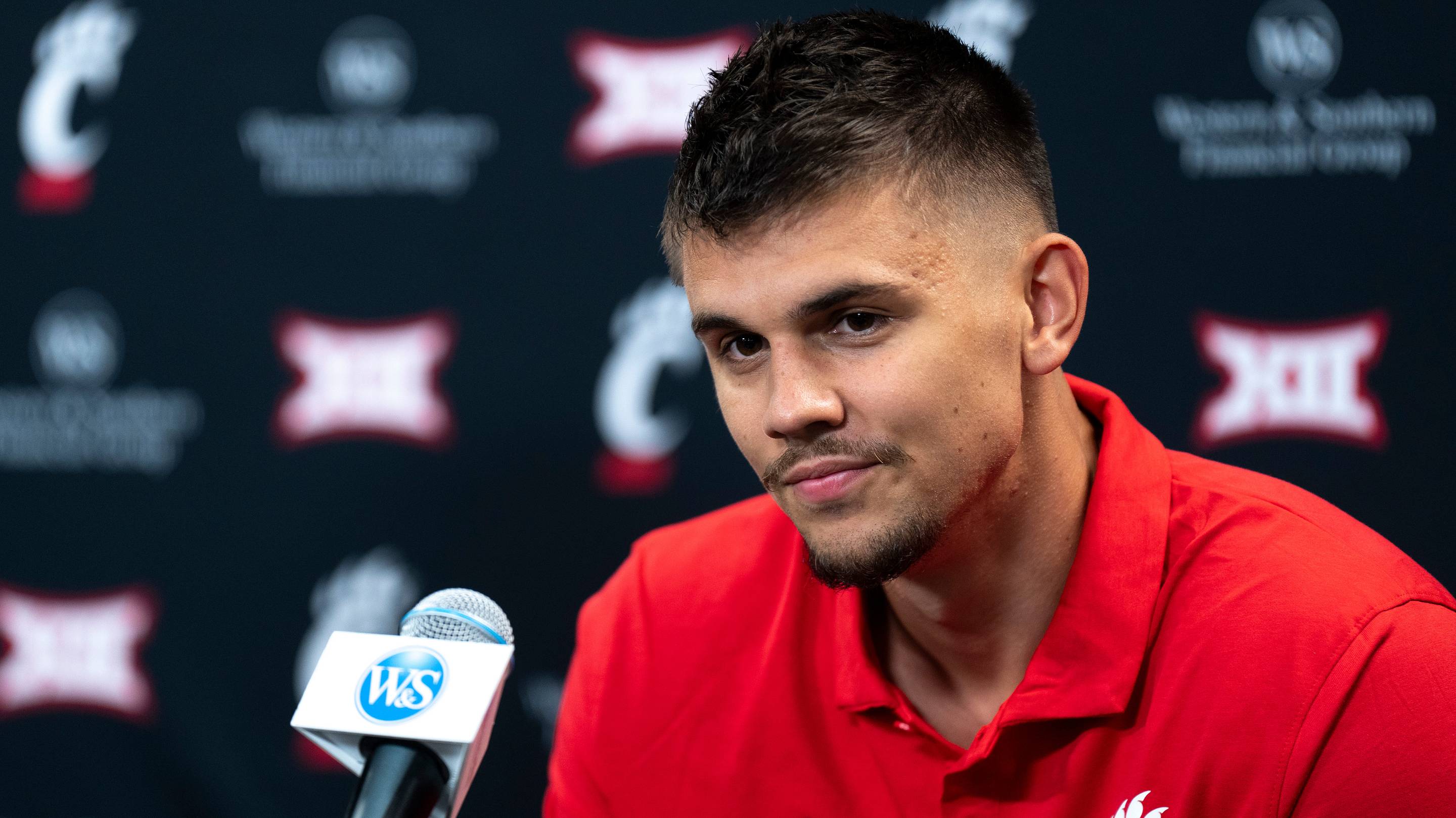 Cincinnati Bearcats guard Kerr Kriisa speaks at a podium at First Third Arena in Cincinnati on Wednesday, July 16, 2025. | USA TODAY Network via Reuters Connect