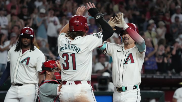 Aug 11, 2024; Phoenix, Arizona, USA; Arizona Diamondbacks outfielder Corbin Carroll (7) celebrates with outfielder Jake McCarthy (31) after hitting a two-run home run against the Philadelphia Phillies in the seventh inning at Chase Field. Mandatory Credit: Rick Scuteri-USA TODAY Sports