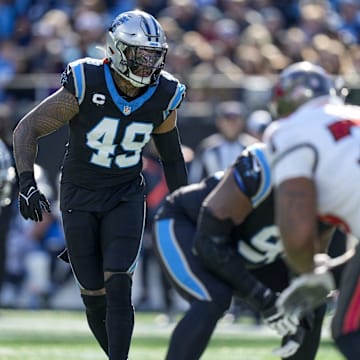 Jan 7, 2024; Charlotte, North Carolina, USA; Carolina Panthers linebacker Frankie Luvu (49) looks over the Tampa Bay Buccaneers offense during the first quarter at Bank of America Stadium. Mandatory Credit: Jim Dedmon-Imagn Images