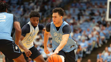 Oct 4, 2025; Charlotte, NC, USA; North Carolina Tar Heels guard Luka Bogavac (44) with the ball as guard Jaydon Young (4) defends in the second half at Dean E. Smith Center. Mandatory Credit: Bob Donnan-Imagn Images