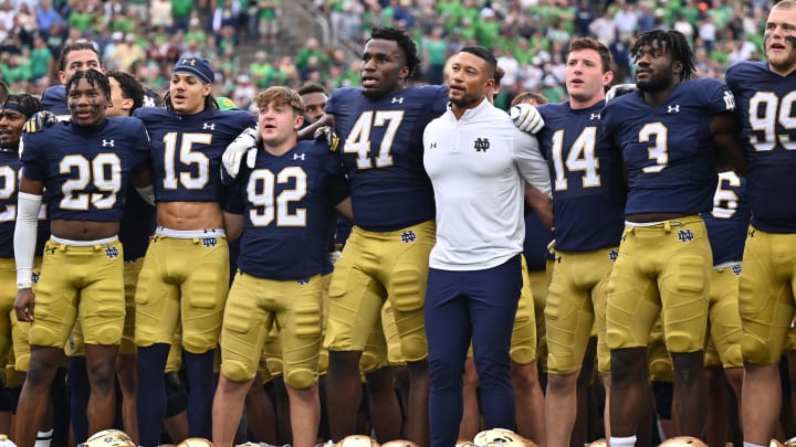 Sep 16, 2023; South Bend, Indiana, USA; Notre Dame Fighting Irish head coach Marcus Freeman stands with his team for the Notre Dame Alma Mater after Notre Dame defeated the Central Michigan Chippewas at Notre Dame Stadium.  