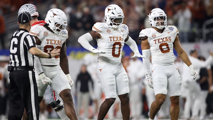 Jan 10, 2025; Arlington, Texas, USA; Texas Longhorns linebacker Anthony Hill Jr. (0) celebrates with linebacker Barryn Sorrell (88) and linebacker Trey Moore (8) after a play during the second quarter of the College Football Playoff semifinal against the Ohio State Buckeyes in the Cotton Bowl at AT&T Stadium. Mandatory Credit: Tim Heitman-Imagn Images Jan 10, 2025; Arlington, Texas, USA; Texas Longhorns linebacker Anthony Hill Jr. (0) celebrates with linebacker Barryn Sorrell (88) and linebacker Trey Moore (8) after a play during the second quarter of the College Football Playoff semifinal against the Ohio State Buckeyes in the Cotton Bowl at AT&T Stadium. Mandatory Credit: Tim Heitman-Imagn Images