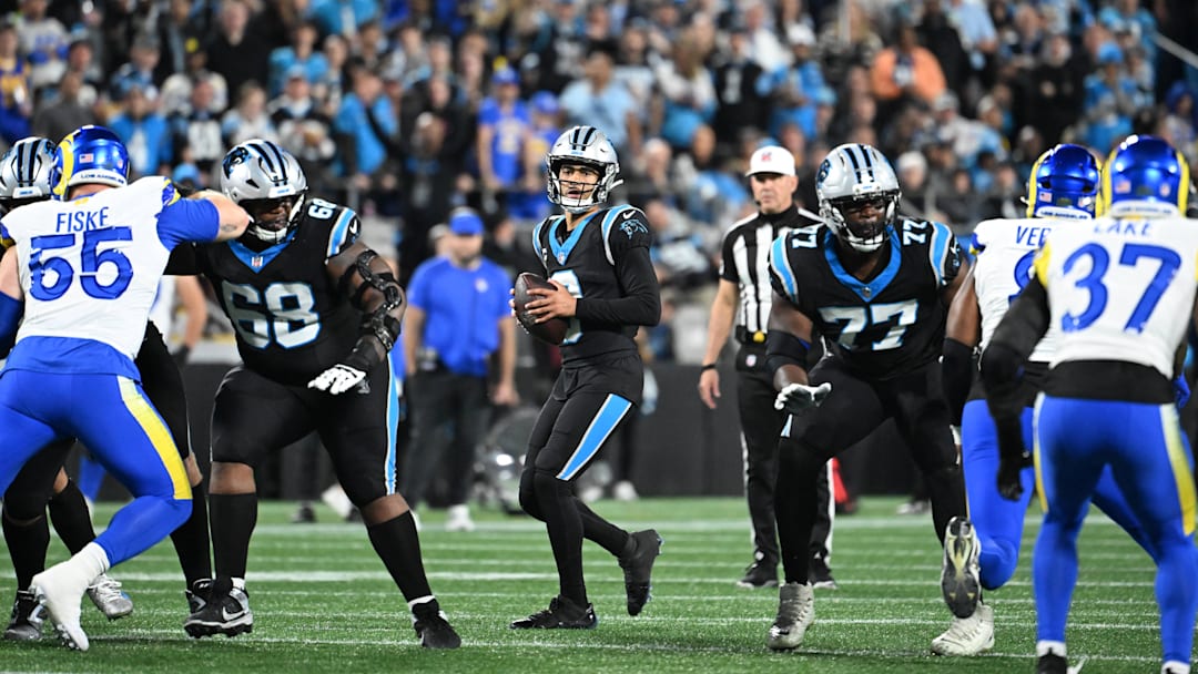 Carolina Panthers quarterback Bryce Young (9) looks to pass as guard Damien Lewis (68) and offensive tackle Yosh Nijman (77) block 