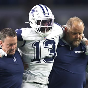 Dallas Cowboys linebacker DeMarvion Overshown is helped off the field after an injury against the Cincinnati Bengals.