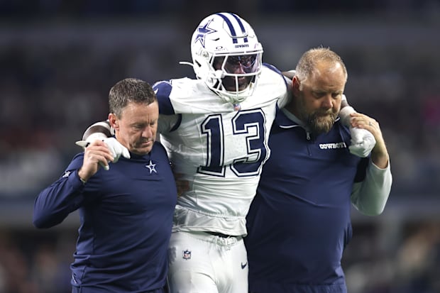 Dallas Cowboys LB DeMarvion Overshown is helped off the field after an injury against the Cincinnati Bengals.