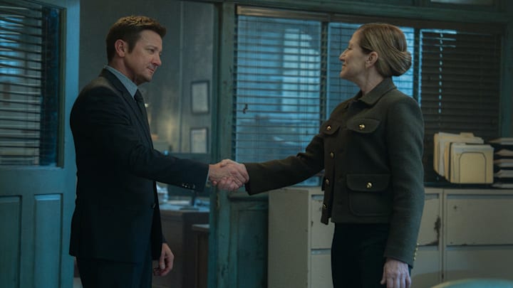 L-R: Jeremy Renner as Mike McLusky and Edie Falco as Nina Hobbs in Mayor of Kingstown episode 1, season 4, streaming on Paramount+, 2025. Credit: Dennis P. Mong Jr./Paramount+