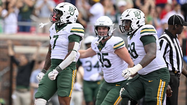 Sep 6, 2025; Dallas, Texas, USA; Baylor Bears running back Bryson Washington (7) and offensive lineman Omar Aigbedion (68) celebrate during the game between the SMU Mustangs and the Baylor Bears at Gerald J. Ford Stadium. Mandatory Credit: Jerome Miron-Imagn Images