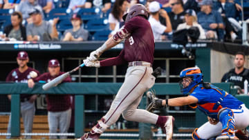 Jun 19, 2024; Omaha, NE, USA; Texas A&M Aggies third baseman Gavin Grahovac (9) hits an RBI double against the Florida Gators during the fifth inning at Charles Schwab Field Omaha. Mandatory Credit: Dylan Widger-USA TODAY Sports