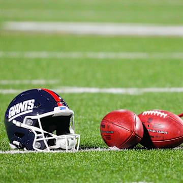 Oct 15, 2023; Orchard Park, New York, USA; A general view of the New York Giants helmet with footballs prior to the game between the New York Giants and Buffalo Bills at Highmark Stadium.  