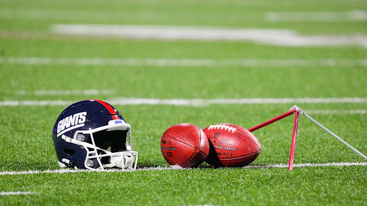 Oct 15, 2023; Orchard Park, New York, USA; A general view of the New York Giants helmet with footballs prior to the game between the New York Giants and Buffalo Bills at Highmark Stadium.  