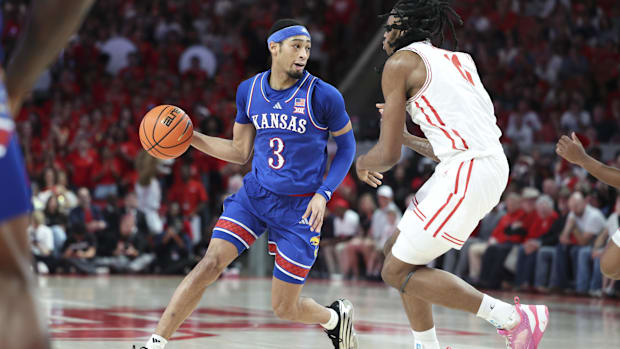 Kansas guard Dajuan Harris dribbles the ball against Housto