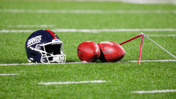 Oct 15, 2023; Orchard Park, New York, USA; A general view of the New York Giants helmet with footballs prior to the game between the New York Giants and Buffalo Bills at Highmark Stadium.  