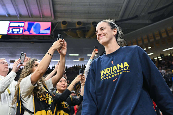 Indiana Fever guard Caitlin Clark walks onto the court before a game against the Brazil National Team at Carver-Haweye Arena.