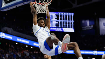 Jan 14, 2025; Lexington, Kentucky, USA; Kentucky Wildcats guard Jaxson Robinson (2) hangs on the rim after dunking the ball during the second half against the Texas A&M Aggies at Rupp Arena at Central Bank Center. Mandatory Credit: Jordan Prather-Imagn Images