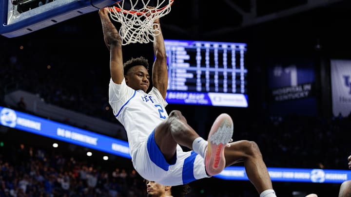 Jan 14, 2025; Lexington, Kentucky, USA; Kentucky Wildcats guard Jaxson Robinson (2) hangs on the rim after dunking the ball during the second half against the Texas A&M Aggies at Rupp Arena at Central Bank Center. Mandatory Credit: Jordan Prather-Imagn Images