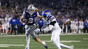 Kansas State quarterback Avery Johnson gets past Kansas defender in Saturday's K-State victory.