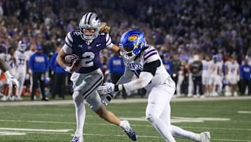Kansas State quarterback Avery Johnson gets past Kansas defender in Saturday's K-State victory.