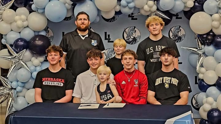 Layton (Utah) wrestling coach Adam Fager (back left) celebrates with five of his wrestlers who cemented their college commitments. They are (back row, right of Fager) Attis Fager and Elijah Hawes, (bottom row from left) Noah Bull, Austin Paris, Lander Bosh and Gavin Regis. Layton (Utah) wrestling coach Adam Fager (back left) celebrates with five of his wrestlers who cemented their college commitments. They are (back row, right of Fager) Attis Fager and Elijah Hawes, (bottom row from left) Noah Bull, Austin Paris, Lander Bosh and Gavin Regis.