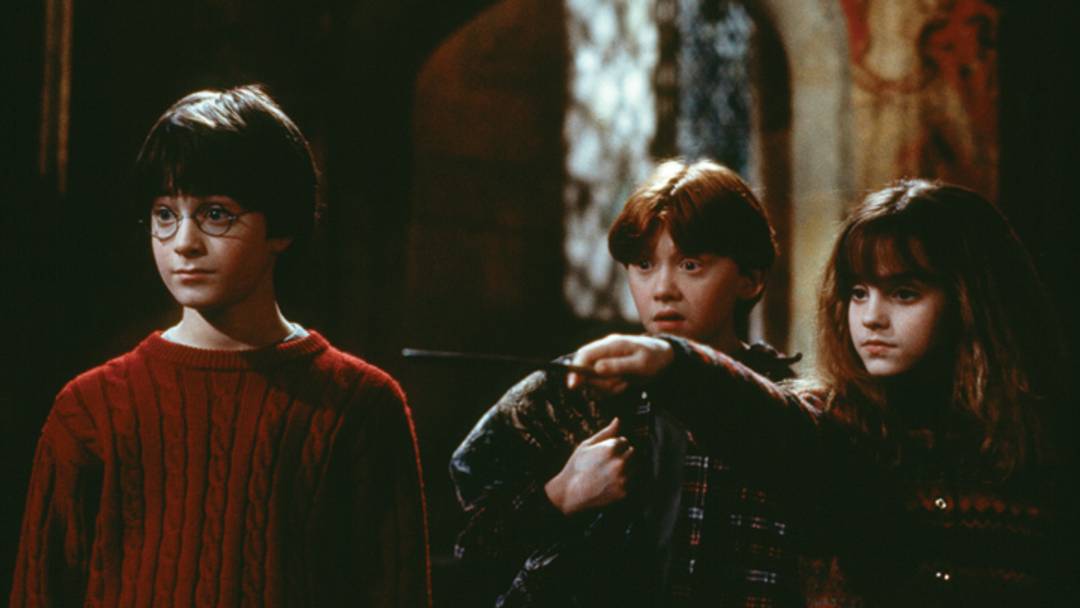 Harry Potter (Daniel Radcliffe), Ron Weasley (Rupert Grint), and Hermione Granger (Emma Watson) in Harry Potter and the Sorcerer's Stone. 