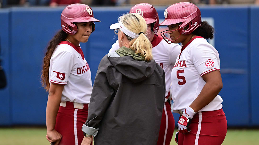 Patty Gasso, Oklahoma softball head coach speaks with redshirt sophomore INF Nelly McEnroe-Marinas and junior UTL Ella Parker during a timeout against the Mississippi State Bulldogs at Devon Park on April 18, 2025 in Oklahoma City.