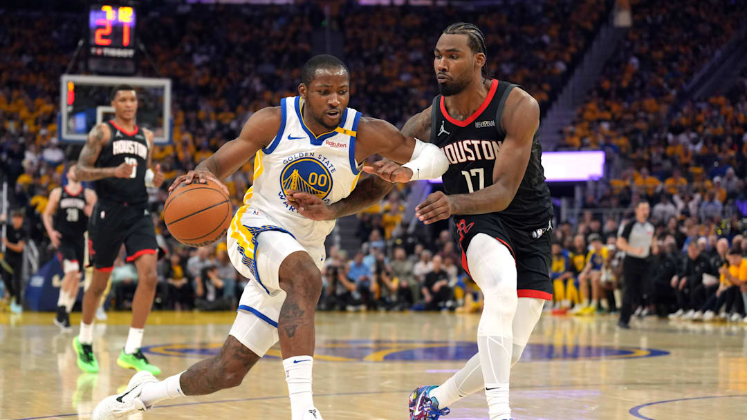 Apr 26, 2025; San Francisco, California, USA; Golden State Warriors forward Jonathan Kuminga (00) dribbles against Houston Rockets forward Tari Eason (17) during the second quarter of game three of first round for the 2024 NBA Playoffs at Chase Center. Mandatory Credit: Darren Yamashita-Imagn Images