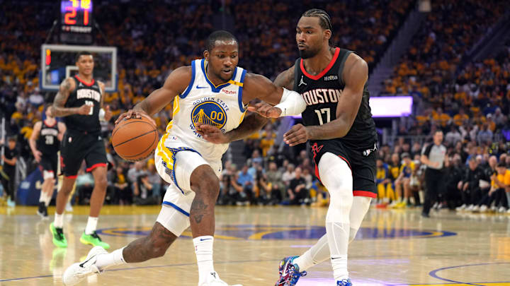Apr 26, 2025; San Francisco, California, USA; Golden State Warriors forward Jonathan Kuminga (00) dribbles against Houston Rockets forward Tari Eason (17) during the second quarter of game three of first round for the 2024 NBA Playoffs at Chase Center. Mandatory Credit: Darren Yamashita-Imagn Images