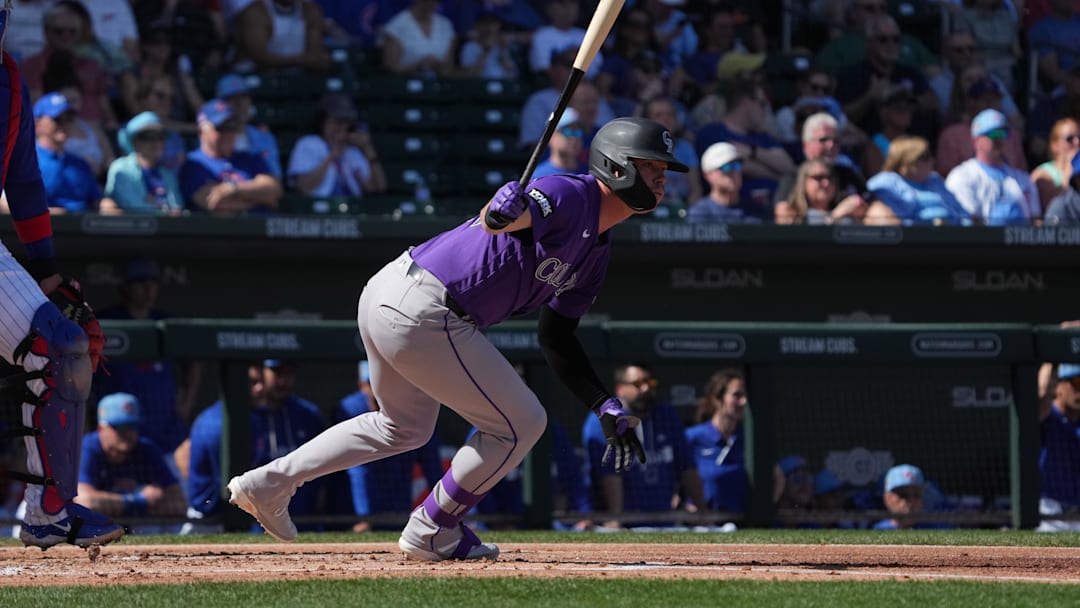 Feb 25, 2026; Mesa, Arizona, USA; Colorado Rockies outfielder Troy Johnston (20) hits against the Chicago Cubs in the first inning at Sloan Park. Mandatory Credit: Rick Scuteri-Imagn Images