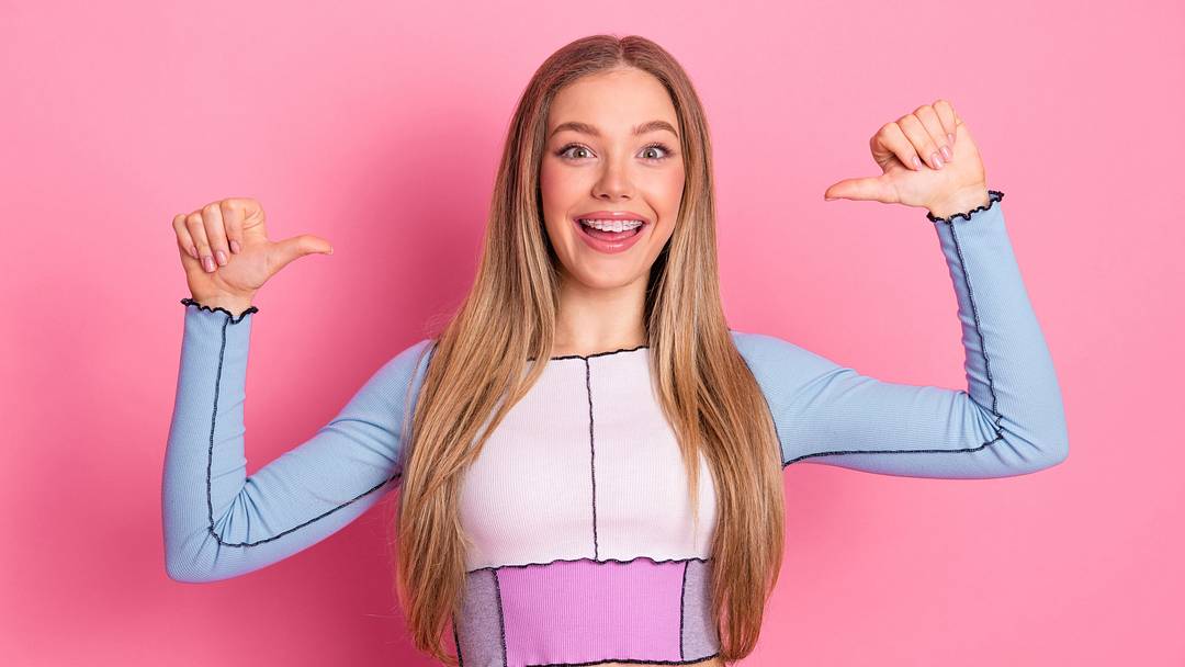 Girl posing with a happy expression and bright outfit