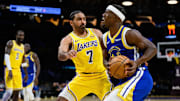 Oct 21, 2025; Los Angeles, California, USA; Golden State Warriors forward Jimmy Butler III (10) drives against Los Angeles Lakers guard Gabe Vincent (7) during the second half at Crypto.com Arena. Mandatory Credit: William Liang-Imagn Images