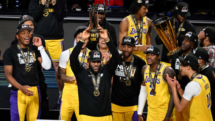 Dec 9, 2023; Las Vegas, Nevada, USA; Los Angeles Lakers forward LeBron James (23) holds the MVP trophy and celebrates with teammates after winning the NBA In-Season Tournament Championship game against the Indiana Pacers at T-Mobile Arena. Mandatory Credit: Candice Ward-USA TODAY Sports