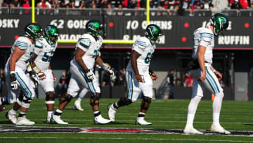 Tulane Green Wave quarterback Michael Pratt (7) and the offensive line walk back to the sideline after a stalled offensive series in the second quarter during a college football game, Friday, Nov. 25, 2022, at Nippert Stadium in Cincinnati.

Ncaaf Tulane Green Wave At Cincinnati Bearcats Nov 25 0107