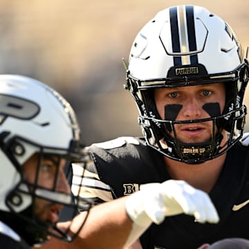 Purdue Boilermakers quarterback Ryan Browne (15) hands off a ball 