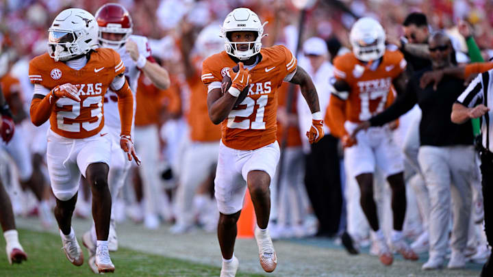 Oct 11, 2025; Dallas, Texas, USA; Texas Longhorns wide receiver Ryan Niblett (21) returns a punt for touchdown against the Oklahoma Sooners during the second half at the Cotton Bowl. Mandatory Credit: Jerome Miron-Imagn Images