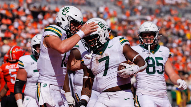 Baylor Bears quarterback Sawyer Robertson (13) celebrates with Baylor Bears running back Bryson Washington (7)