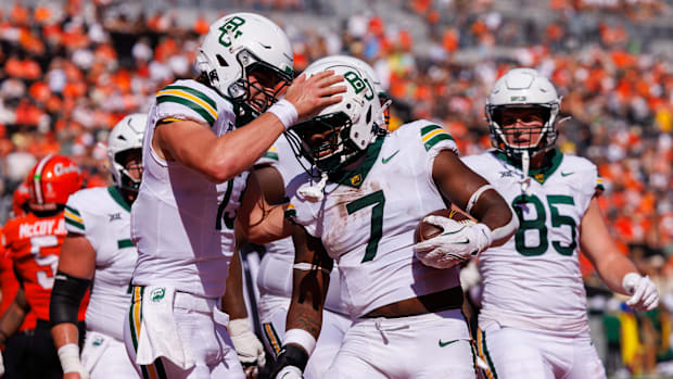 Baylor Bears quarterback Sawyer Robertson (13) celebrates with Baylor Bears running back Bryson Washington (7) 