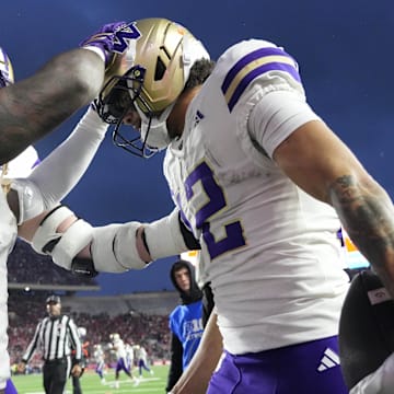 Huskies wide receiver Denzel Boston (12) celebrates a touchdown catch against Wisconsin.