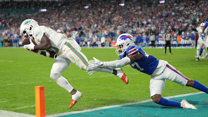 Jan 7, 2024; Miami Gardens, Florida, USA;  Miami Dolphins wide receiver Tyreek Hill (10) catches a touchdown as Buffalo Bills cornerback Christian Benford (47) defends on the play during the first half at Hard Rock Stadium. Mandatory Credit: Jim Rassol-USA TODAY Sports