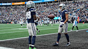 Dallas Cowboys wide receiver CeeDee Lamb reacts with wide receiver Jalen Tolbert after catching a touchdown pass in the second quarter at Bank of America Stadium.