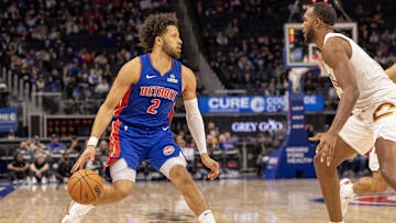 Feb 5, 2025; Detroit, Michigan, USA; Detroit Pistons guard Cade Cunningham (2) moves the ball up court on Cleveland Cavaliers forward Evan Mobley (4) during the first half at Little Caesars Arena. Mandatory Credit: David Reginek-Imagn Images