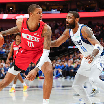 Apr 7, 2024; Dallas, Texas, USA; Dallas Mavericks guard Kyrie Irving (11) guards Houston Rockets forward Jabari Smith Jr. (10) during the third quarter at American Airlines Center. Mandatory Credit: Andrew Dieb-Imagn Images